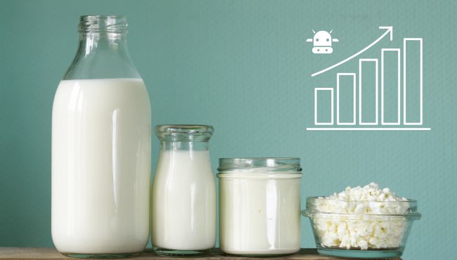 Mesa com leite e outros produtos lácteos com um gráfico de aumento de produção representando a importância do acompanhamento da atividade leiteira para melhores resultados.